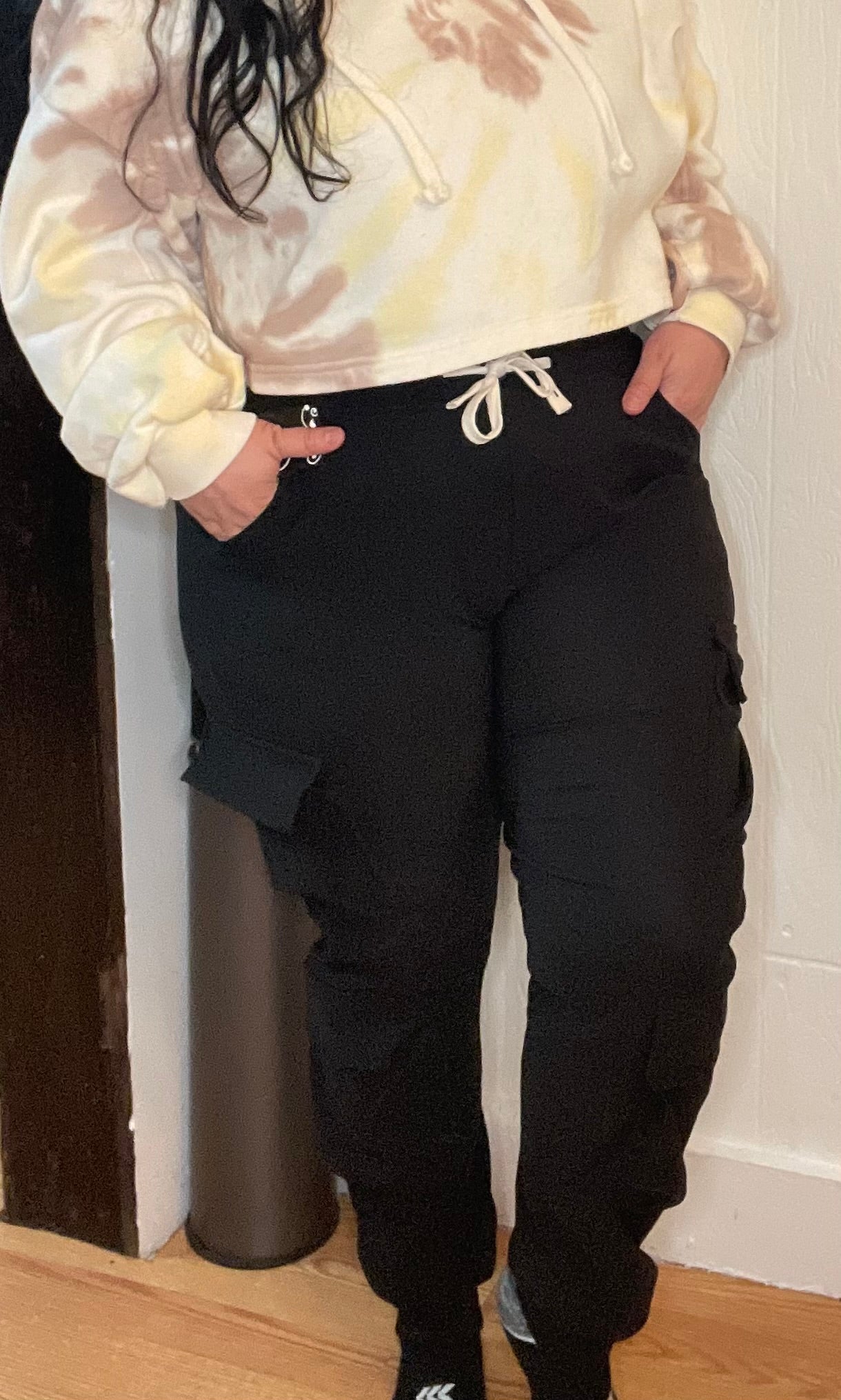 Black cargo joggers with regular pockets and additional pockets on both legs for versatile storage