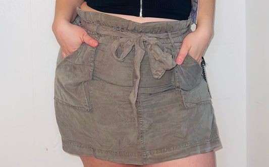 Olive green skort featuring a comfortable and stylish design, ideal for versatile outfit options. Perfect for casual or active wear, offering the comfort of shorts with the elegance of a skirt