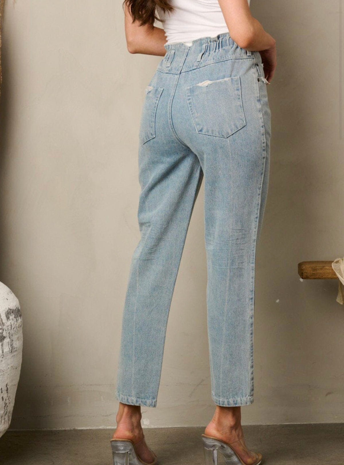 Clear Sky Jeans: High-waisted, elastic, button closure, 100% cotton. Elevate your style with comfort and timeless fashion.